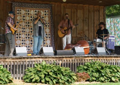 A band on stage at an outdoor venue
