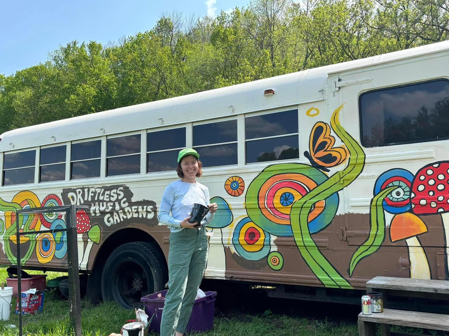 A woman outside a painted bus