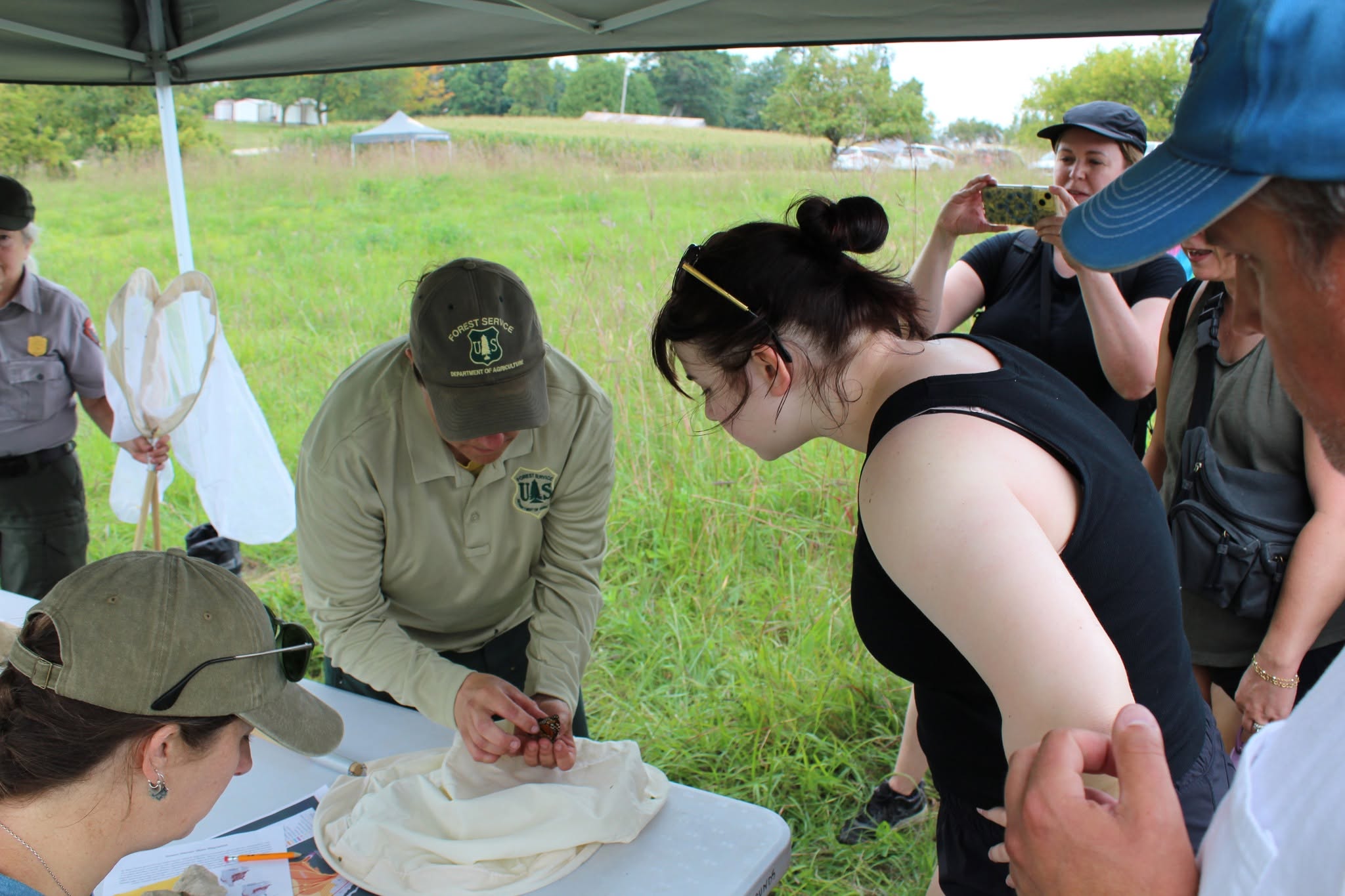 effigy mounds People gather around a forestry service member with a butterfly
